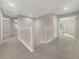 Upstairs hallway featuring neutral carpet, white railing, and multiple bedroom access at 9003 Willowbrook Cir, Bradenton, FL 34212