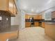 Well-lit kitchen featuring tile flooring, ample wood cabinetry, and stainless steel appliances at 9003 Willowbrook Cir, Bradenton, FL 34212