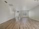 Expansive living room boasting wood flooring, bright white walls, and a welcoming entryway at 9003 Willowbrook Cir, Bradenton, FL 34212