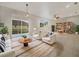 Inviting living room with neutral tones, tile flooring, and sliding glass doors to the outdoors at 9003 Willowbrook Cir, Bradenton, FL 34212