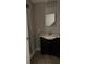 Bathroom featuring a black vanity and a shower at 910 Seminole St, Clearwater, FL 33755