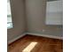 Bright bedroom with hardwood floors, white trim, and natural light from two windows at 910 Seminole St, Clearwater, FL 33755