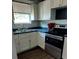 Updated kitchen featuring white cabinetry, stainless steel appliances, and modern backsplash at 910 Seminole St, Clearwater, FL 33755