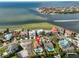 Aerial view of a waterfront property with pool, pier and boatlift close to beach at 912 Symphony Beach Ln, Apollo Beach, FL 33572