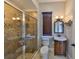 Bathroom with a walk-in shower and a vanity with dark wood accents at 912 Symphony Beach Ln, Apollo Beach, FL 33572