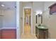 Bathroom hallway with a modern vanity, glass sink and travertine floors at 912 Symphony Beach Ln, Apollo Beach, FL 33572