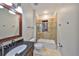 Neutral bathroom featuring a shower and a vanity with dark wood accents at 912 Symphony Beach Ln, Apollo Beach, FL 33572