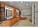 Bathroom with double sinks, granite counters, tub, and glass enclosed shower at 912 Symphony Beach Ln, Apollo Beach, FL 33572