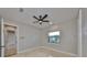 Neutral bedroom featuring tile flooring, a ceiling fan, and a window at 912 Symphony Beach Ln, Apollo Beach, FL 33572