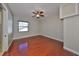 Bedroom featuring wood floors, a ceiling fan, and neutral-colored walls at 912 Symphony Beach Ln, Apollo Beach, FL 33572