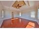 Spacious bedroom featuring tray ceiling, wood floors, and recessed lighting at 912 Symphony Beach Ln, Apollo Beach, FL 33572