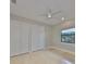 Clean bedroom featuring tile flooring, a ceiling fan, and a large closet at 912 Symphony Beach Ln, Apollo Beach, FL 33572