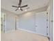 Neutral bedroom featuring tile flooring, a ceiling fan, and two closets at 912 Symphony Beach Ln, Apollo Beach, FL 33572