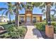 Exterior of the community clubhouse with a well-manicured lawn and tropical landscaping at 912 Symphony Beach Ln, Apollo Beach, FL 33572