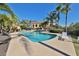 Community pool surrounded by lounge chairs, tropical landscaping, and clear blue skies at 912 Symphony Beach Ln, Apollo Beach, FL 33572