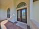 Front entryway featuring decorative glass doors, tile floor, and stone balustrade at 912 Symphony Beach Ln, Apollo Beach, FL 33572