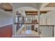 Foyer view with wood railing, arched accents and a fireplace at 912 Symphony Beach Ln, Apollo Beach, FL 33572