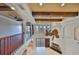 Foyer featuring wood railing, wood beam ceiling, arched accents and a fireplace at 912 Symphony Beach Ln, Apollo Beach, FL 33572