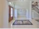 Inviting foyer with elegant marble floors, arched doorways, and staircase with wrought iron railing at 912 Symphony Beach Ln, Apollo Beach, FL 33572