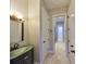 Hallway with bathroom featuring green accents and tile flooring at 912 Symphony Beach Ln, Apollo Beach, FL 33572