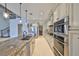 Kitchen featuring marble floors, a large island, and professional-grade appliances at 912 Symphony Beach Ln, Apollo Beach, FL 33572