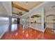 Spacious living area featuring wooden beams, hardwood floors, and balcony access at 912 Symphony Beach Ln, Apollo Beach, FL 33572