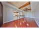 Open floor plan living area with wood beam ceiling, hardwood floors and wrought iron railing at 912 Symphony Beach Ln, Apollo Beach, FL 33572