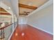 Spacious living room featuring wood floors, ceiling fan, and decorative beams at 912 Symphony Beach Ln, Apollo Beach, FL 33572