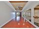 Living area featuring wood beam ceiling, hardwood floors and wrought iron railing at 912 Symphony Beach Ln, Apollo Beach, FL 33572