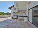 Built-in outdoor kitchen with stainless steel appliances and stone accents on spacious patio at 912 Symphony Beach Ln, Apollo Beach, FL 33572