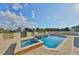 Beautiful pool and spa surrounded by a stone patio and decorative fence overlooking the waterfront at 912 Symphony Beach Ln, Apollo Beach, FL 33572