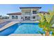 A beautiful pool and patio area are adjacent to the home with large windows and sliding glass doors at 912 Symphony Beach Ln, Apollo Beach, FL 33572