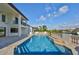 This pool features an adjacent patio and a waterfall that looks out over the water at 912 Symphony Beach Ln, Apollo Beach, FL 33572