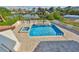 Aerial view of a backyard showcasing a pool, spa and luxurious patio with outdoor living at 912 Symphony Beach Ln, Apollo Beach, FL 33572