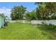 Spacious backyard featuring a well-maintained lawn and a white vinyl fence for added privacy at 9321 Regatta Cir, Spring Hill, FL 34606