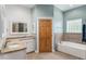 Bright bathroom featuring double sink granite vanity and a separate tub at 9321 Regatta Cir, Spring Hill, FL 34606