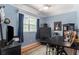 Blue bedroom featuring a TV, dark wood furnishings, and a window with light at 9321 Regatta Cir, Spring Hill, FL 34606