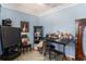 Blue bedroom featuring a TV, dark wood furnishings, and a window with light at 9321 Regatta Cir, Spring Hill, FL 34606