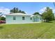 Charming single-story home with vibrant light-blue exterior and well-maintained front yard at 9321 Regatta Cir, Spring Hill, FL 34606