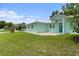 Lovely home with a well-manicured lawn, light-blue facade, and welcoming entrance at 9321 Regatta Cir, Spring Hill, FL 34606