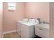 Functional laundry room with a washer, dryer, and utility sink for added convenience at 9321 Regatta Cir, Spring Hill, FL 34606