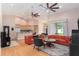 Bright living room with hardwood floors, orange sofas, and sliding glass doors to the backyard at 9321 Regatta Cir, Spring Hill, FL 34606