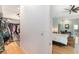 View from a walk-in closet into a main bedroom featuring hardwood floors and a tray ceiling with a ceiling fan at 9321 Regatta Cir, Spring Hill, FL 34606