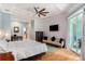 Bright main bedroom featuring white bedding, ceiling fan, and access to the backyard at 9321 Regatta Cir, Spring Hill, FL 34606