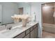 Bathroom with double vanity, sleek countertops, and a shower-tub combo at 9806 Crescent Moon Dr, Riverview, FL 33578