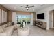 Bright living room with neutral colors, modern furnishings and large glass sliding doors to the outside patio at 9806 Crescent Moon Dr, Riverview, FL 33578