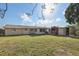 Spacious backyard featuring a lush lawn, shed, and part of the back of the house at 5117 Cape Cod Dr, Holiday, FL 34690