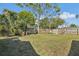 View of the large backyard featuring a wooded fence and seating area at 5117 Cape Cod Dr, Holiday, FL 34690