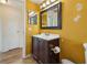 Bathroom featuring a vanity with dark wood cabinets and a large mirror at 5117 Cape Cod Dr, Holiday, FL 34690