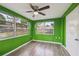 Bright bedroom features wood flooring, a ceiling fan and dual windows overlooking the yard at 5117 Cape Cod Dr, Holiday, FL 34690